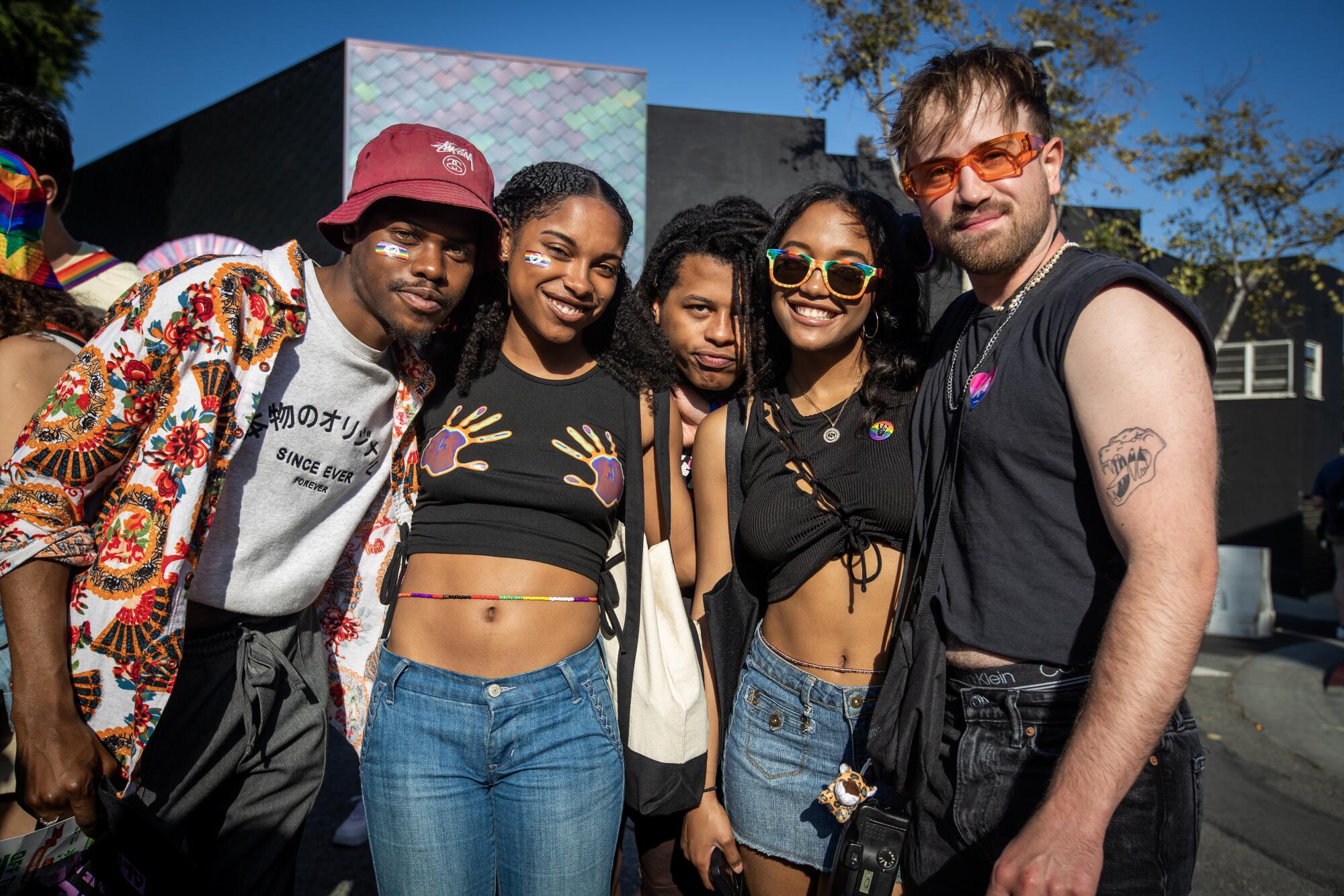 A group of people pose while celebrating at the WeHo Pride Festival