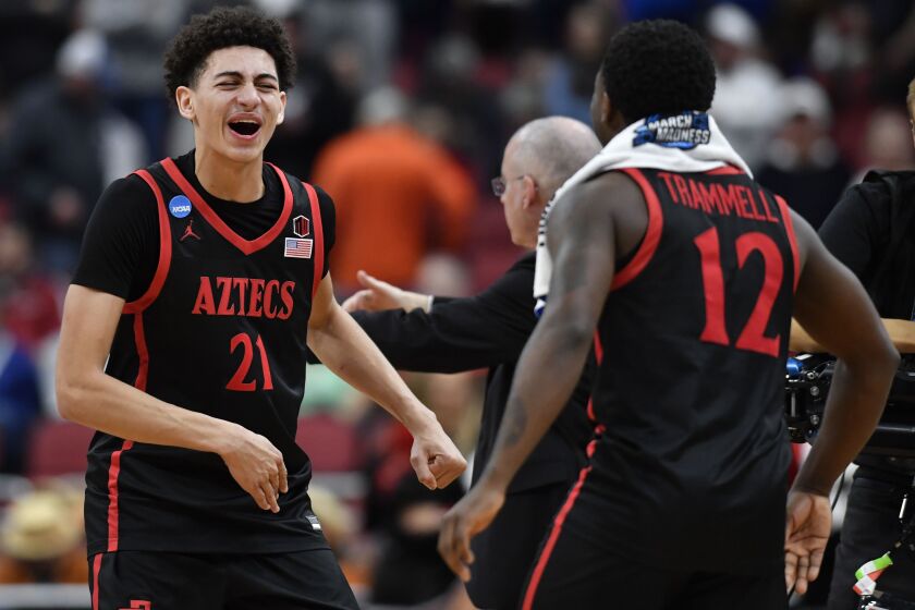 San Diego State's Miles Byrd (21) and Darrion Trammell (12) celebrate a win over Alabamaa in the second half of a Sweet 16 round college basketball game in the South Regional of the NCAA Tournament, Friday, March 24, 2023, in Louisville, Ky. San Diego State won 71-64. (AP Photo/Timothy D. Easley)