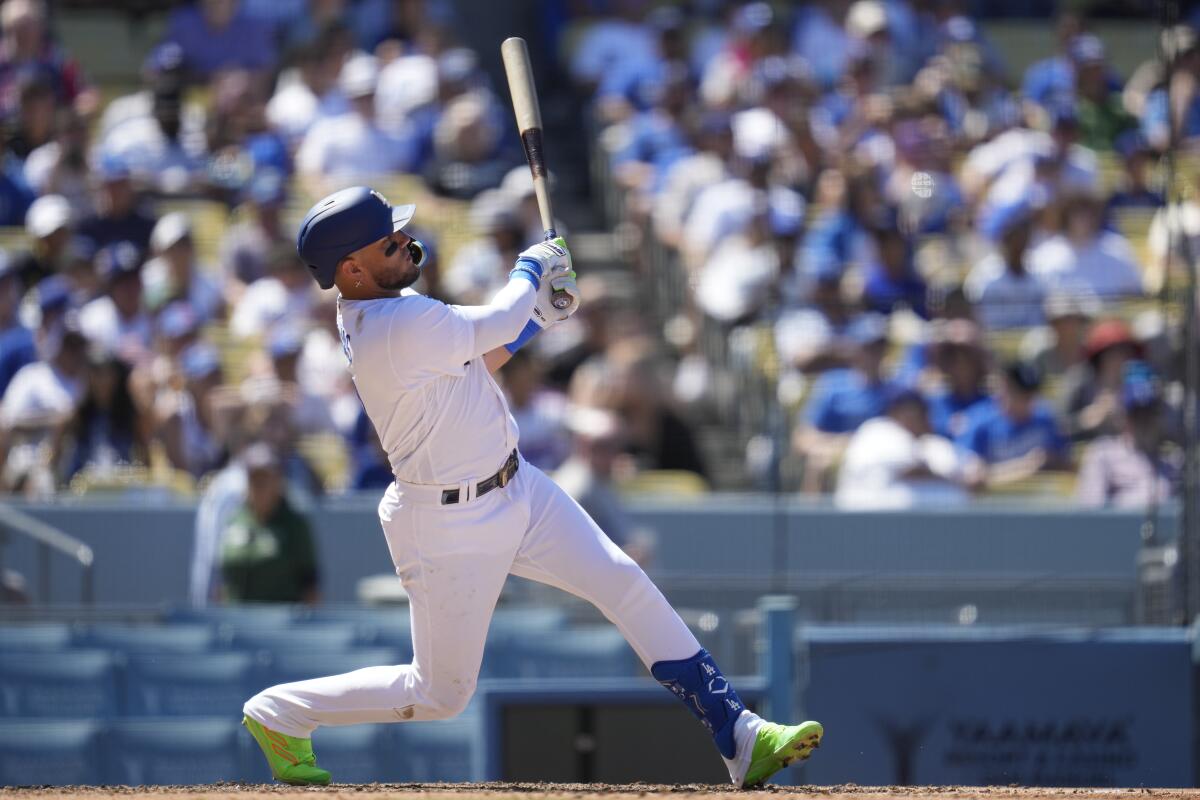 Miguel Rojas doubles for the Dodgers in the fifth inning Sunday against the Atlanta Braves.