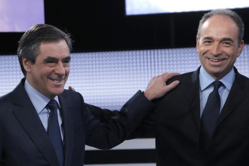 In this Oct. 25 file photo, former French Prime Minister Francois Fillon, left, and French conservative party UMP secretary-general Jean-Francois Cope pose for photographers before a televised debate in Saint Denis, outside Paris.