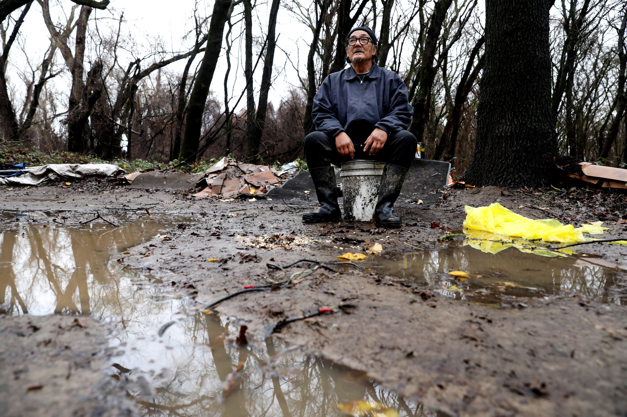 Antonio Rico takes a break while moving some of his belongings from a homeless encampment on Bannon Island