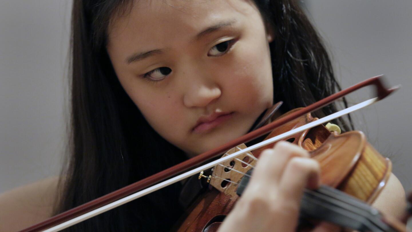 Violinist Hannah Song, 14, rehearses for her performance Tuesday at Walt Disney Concert Hall as part of the Music Center's Spotlight program, a scholarship initiative dedicated to the arts.