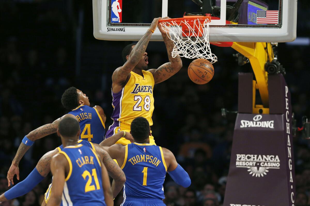 Tarik Black gets a late game dunk in against the Warriors during the Lakers' 109-88 loss to Golden State at Staples Center on Jan. 5.