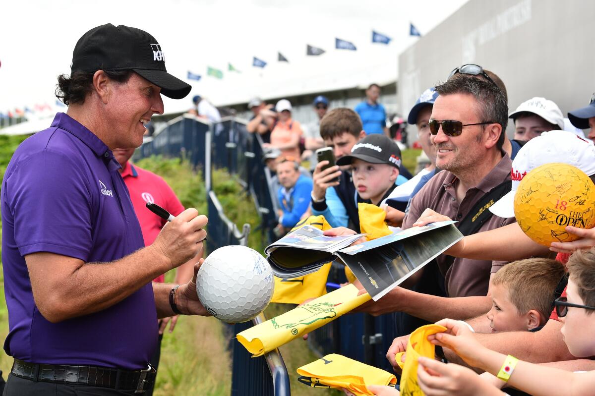 Phil Mickelson signs autographs at the 18th hole at Royal Portrush on July 16.