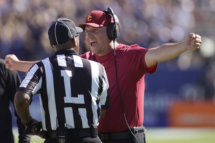 Southern California head coach Clay Helton argues with an official in the second half of an NCAA college football game against BYU, Saturday, Sept. 14, 2019, in Provo, Utah. BYU defeated USC 30-27. (AP Photo/George Frey)
