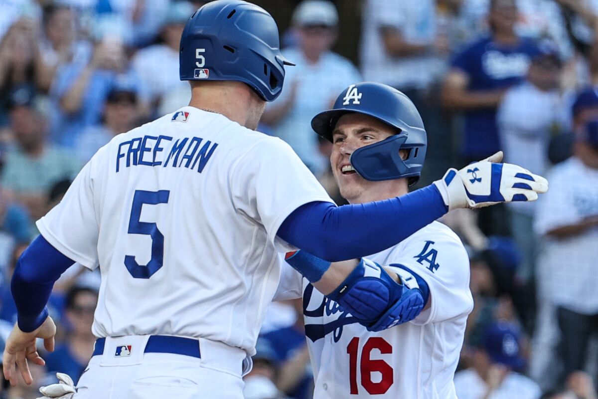 Dodgers catcher Will Smith, right, celebrates with Freddie Freeman after hitting a two-run home run.