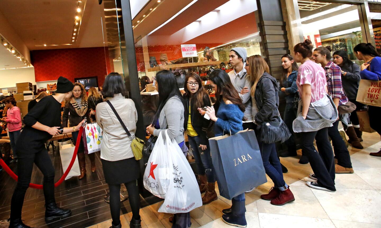 Shoppers line up outside the Steve Madden store at Orange County's South Coast Plaza for a chance to pass through the red velvet rope on Black Friday afternoon.