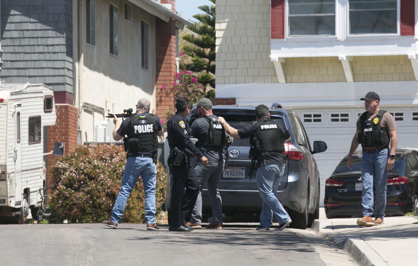 Heavily armed San Diego police officer retreated from a house thought to be the home of 19 year-old John T. Earnest, who is a suspect in the shooting of four people in a Poway synagogue, killing one, on Saturday April 27, 2019 in San Diego, California. The house is on a cut de sac in the Rancho Peñasquitos neighborhood in the north part of the city.