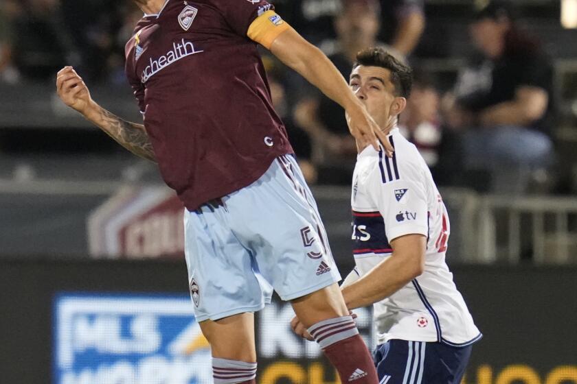 Colorado Rapids defender Andreas Maxso (5) heads the ball next to Vancouver Whitecaps forward Brian White (24) during the first half of an MLS soccer match Wednesday, Sept. 27, 2023, in Commerce City, Colo. (AP Photo/Jack Dempsey)