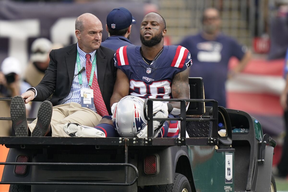 New England Patriots running back James White (28) is carted off the field after an apparent injury during the first half of an NFL football game against the New Orleans Saints, Sunday, Sept. 26, 2021, in Foxborough, Mass. (AP Photo/Steven Senne)