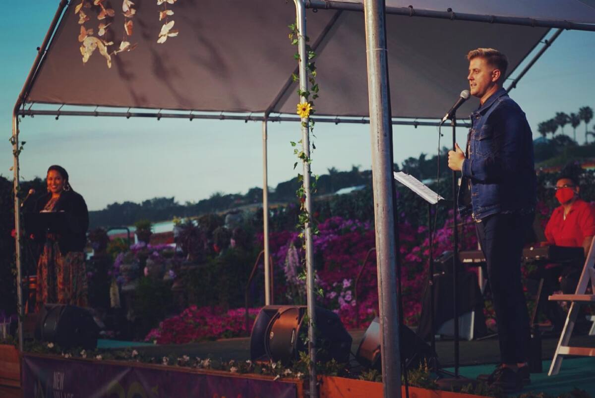 Singers Jasmine January, left, and Zackary Scot Wolfe sing at the Flower Fields in Carlsbad