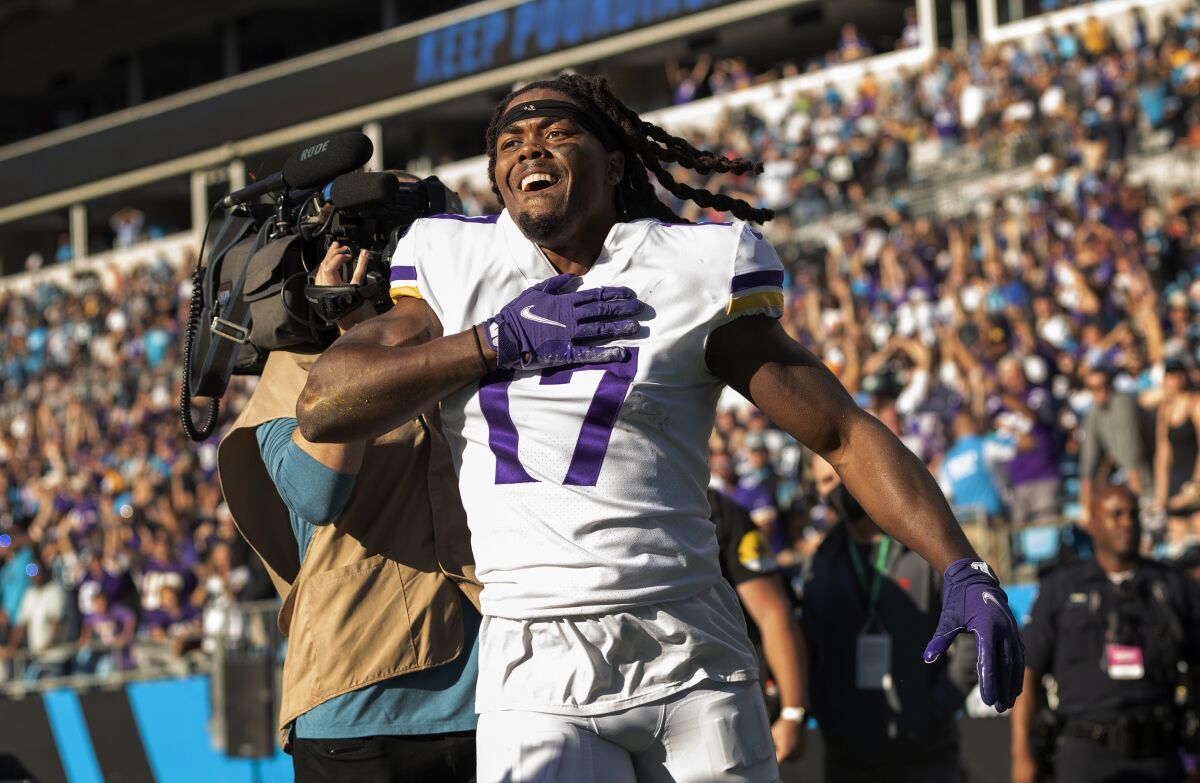 Minnesota Vikings receiver K.J. Osborn (17) celebrates after catching a 27-yard touchdown reception in overtime of an NFL football game against the Carolina Panthers, Sunday, Oct. 17, 2021, in Charlotte, N.C. (Carlos Gonzalez/Star Tribune via AP)