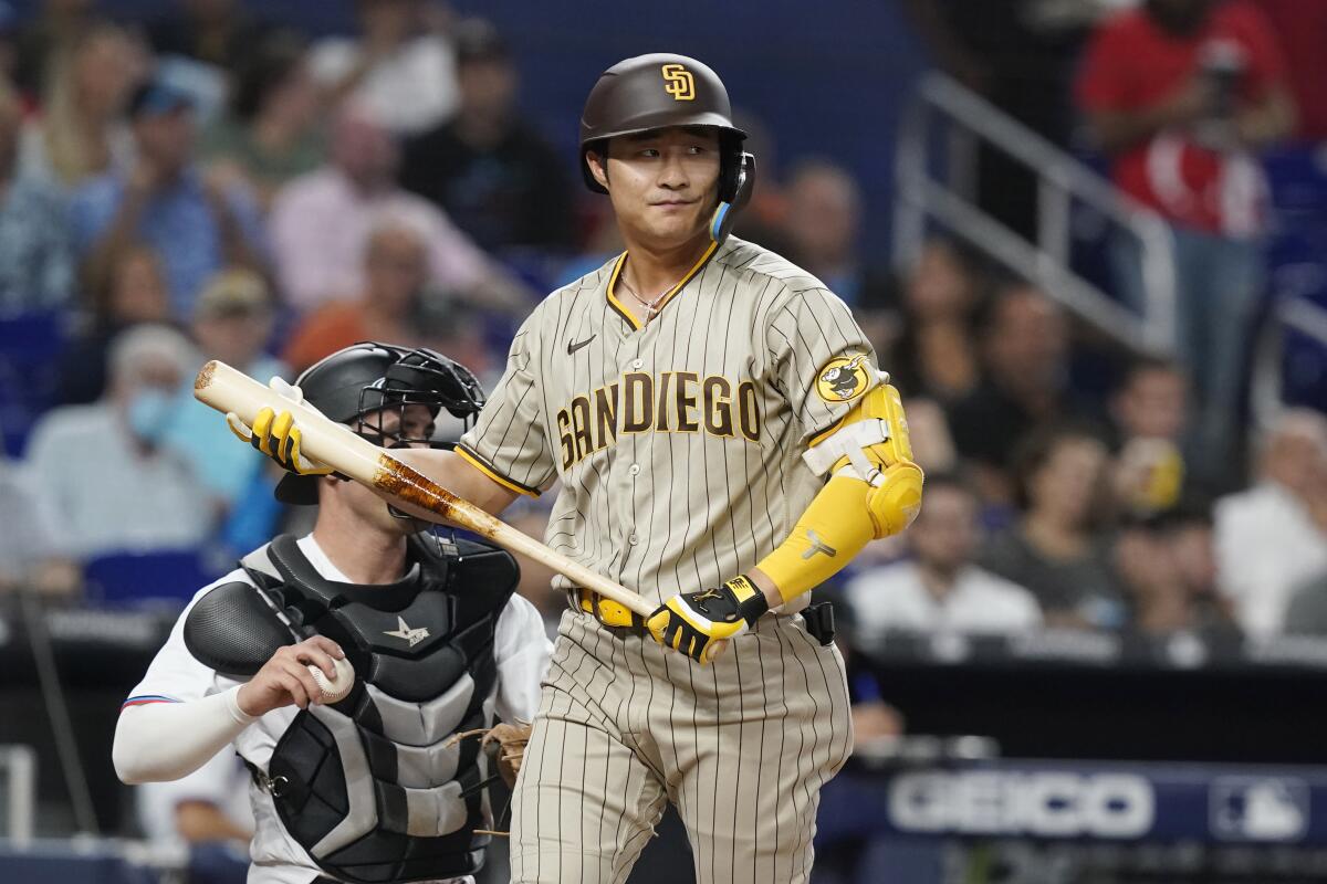 The Padres' Ha-Seong Kim walks back to dugout after striking out in the second inning against the Marlins' Edward Cabrera.