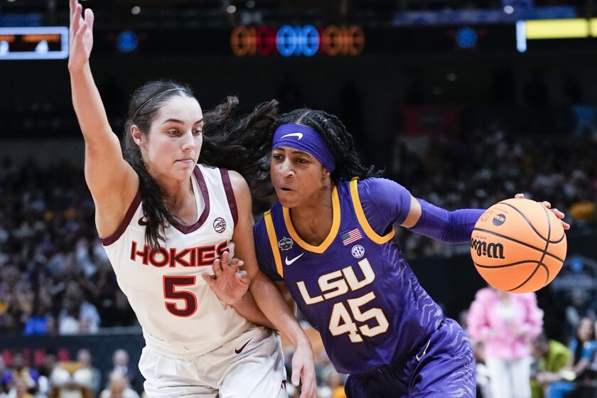 Louisiana State's Alexis Morris drives on Virginia Tech's Georgia Amoore on March 31, 2023, in Dallas.