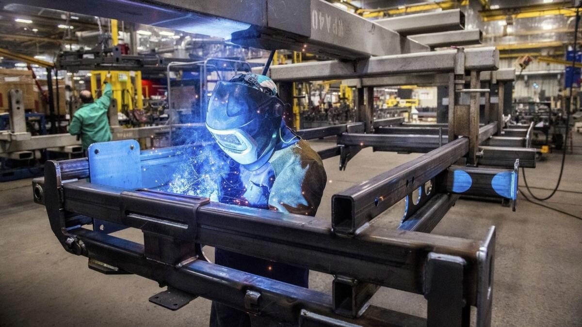 Tyler Snowden of Case IH-Goodfield welds a field cultivator main frame on the shop floor at the plant in Goodfield, Ill.