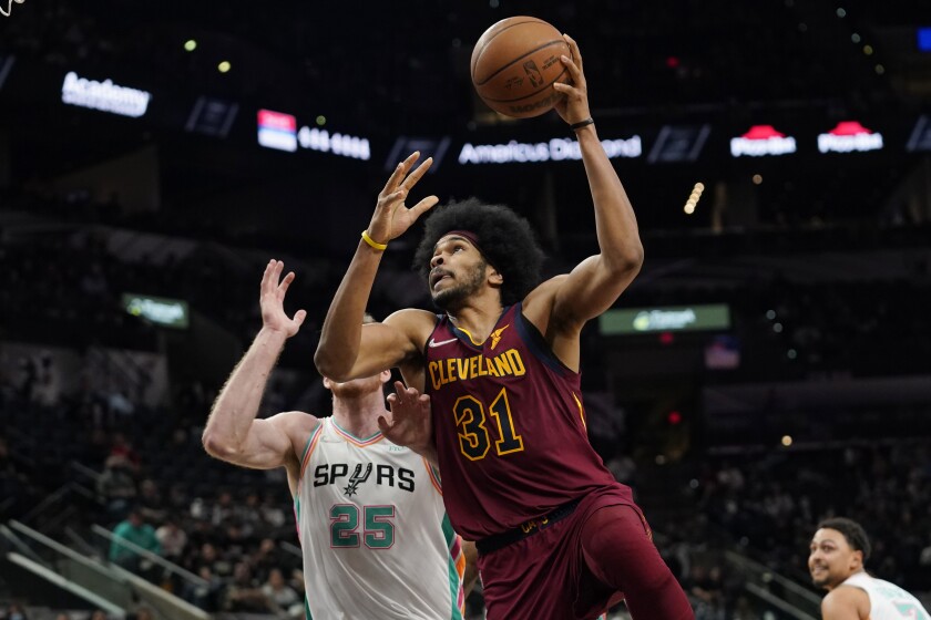 Cleveland Cavaliers center Jarrett Allen (31) shoots over San Antonio Spurs center Jakob Poeltl (25) during the first half of an NBA basketball game, Friday, Jan. 14, 2022, in San Antonio. (AP Photo/Eric Gay)