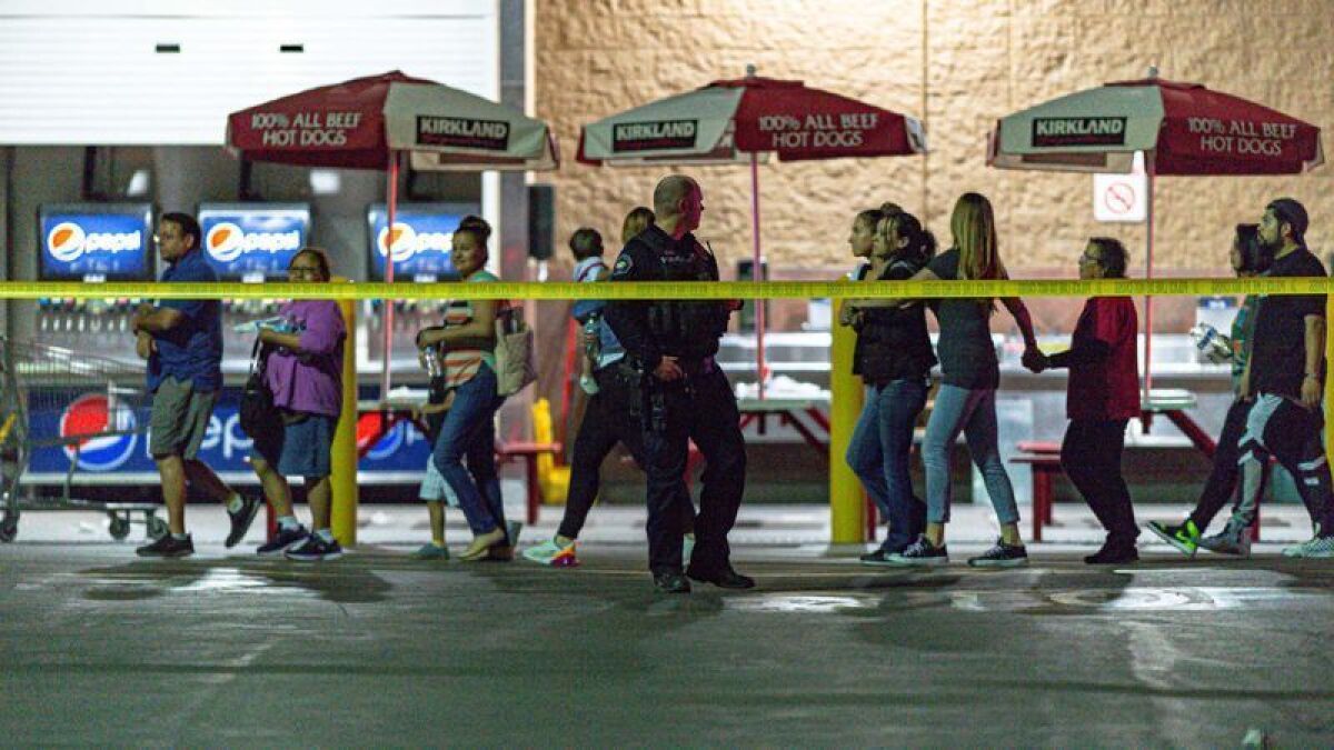Customers leave the Costco in Corona after a shooting involving an off-duty LAPD officer last June.