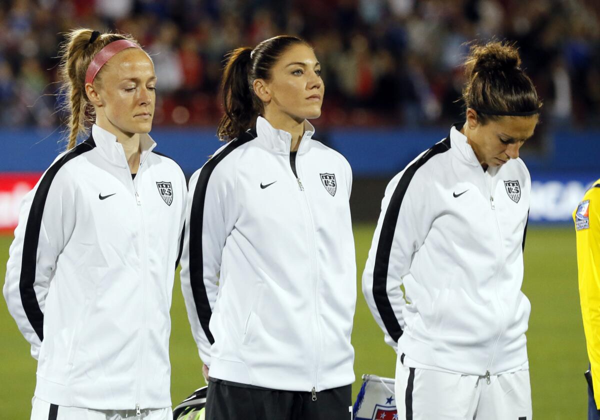 Becky Sauerbrunn, from left, Hope Solo and Carli Lloyd of the U.S. stand on the field during team introductions before a CONCACAF Olympic qualifying match against Costa Rica on Feb. 10.