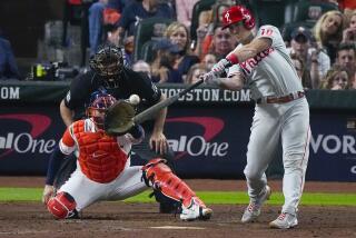 Philadelphia Phillies' J.T. Realmuto hits a home run during the 10th inning in Game 1 of baseball's World Series between the Houston Astros and the Philadelphia Phillies on Friday, Oct. 28, 2022, in Houston. (AP Photo/Sue Ogrocki)