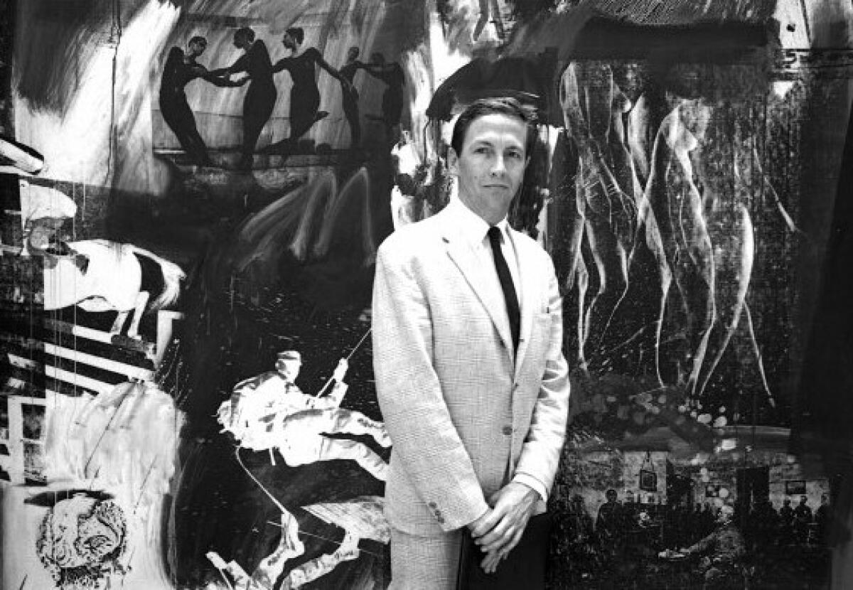 Robert Rauschenberg, 38, shown in suit and tie in front of series of artworks.