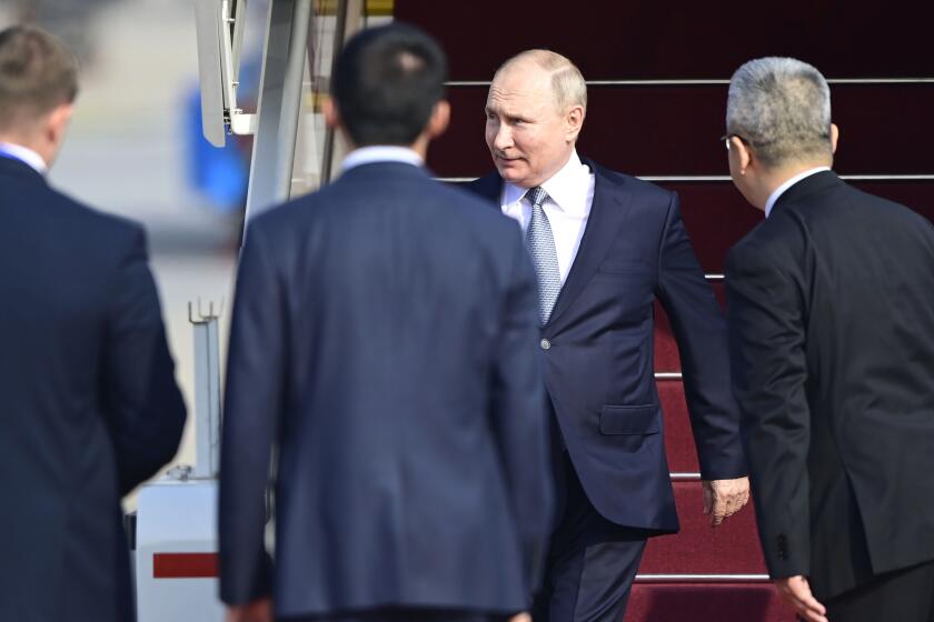 Russia's President Vladimir Putin, rear center, arrives at Beijing Capital International Airport to attend the third Belt and Road Forum in Beijing, Tuesday, Oct. 17, 2023. (Parker Song/Pool Photo via AP)