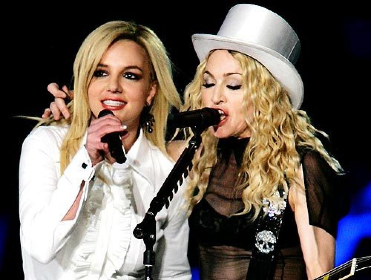 Madonna, with special guest singer Britney Spears, performs during her Sticky and Sweet Tour at Dodger Stadium. More photos >>>