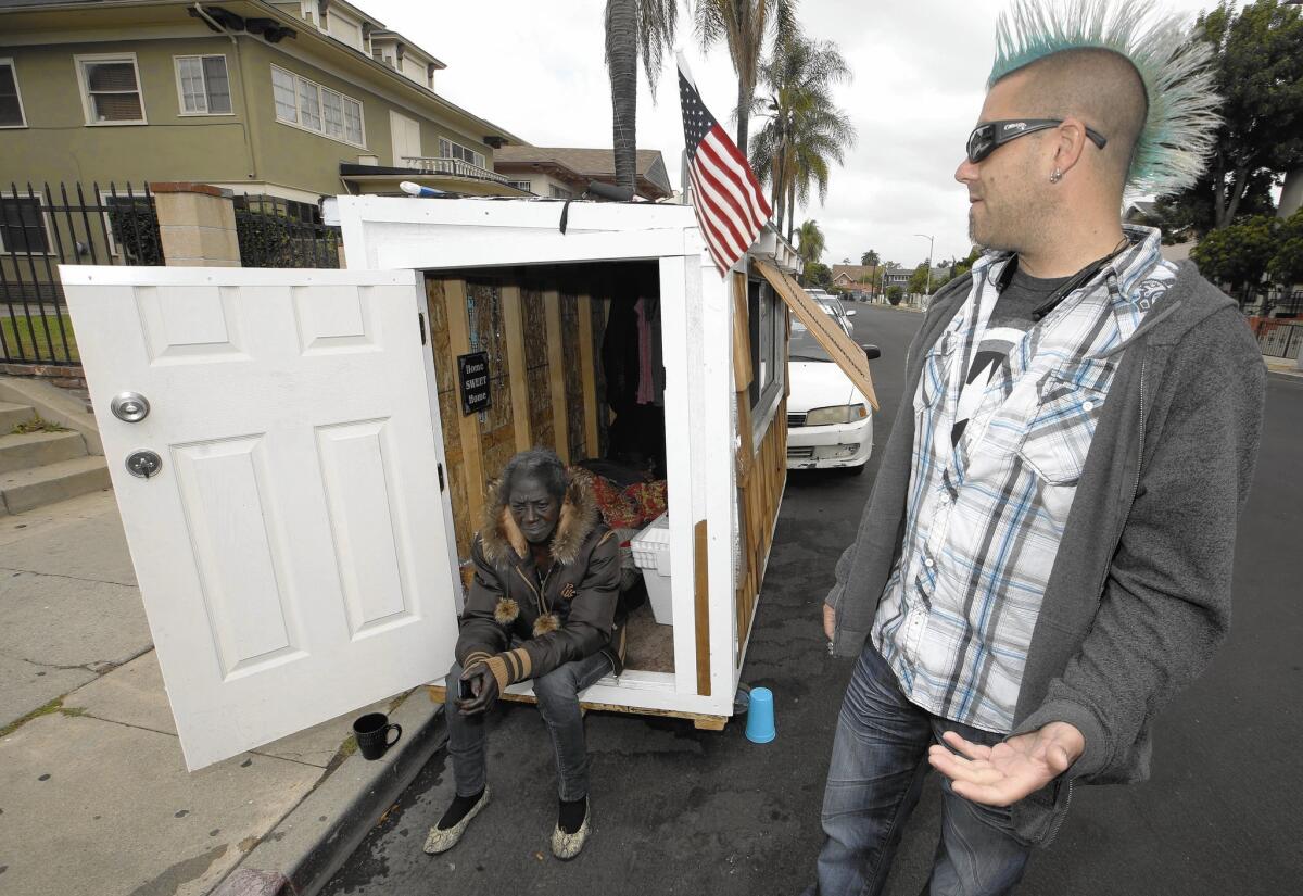 Elvis Summers, right, with a tiny house on wheels he built for Irene "Smokie" McGhee.