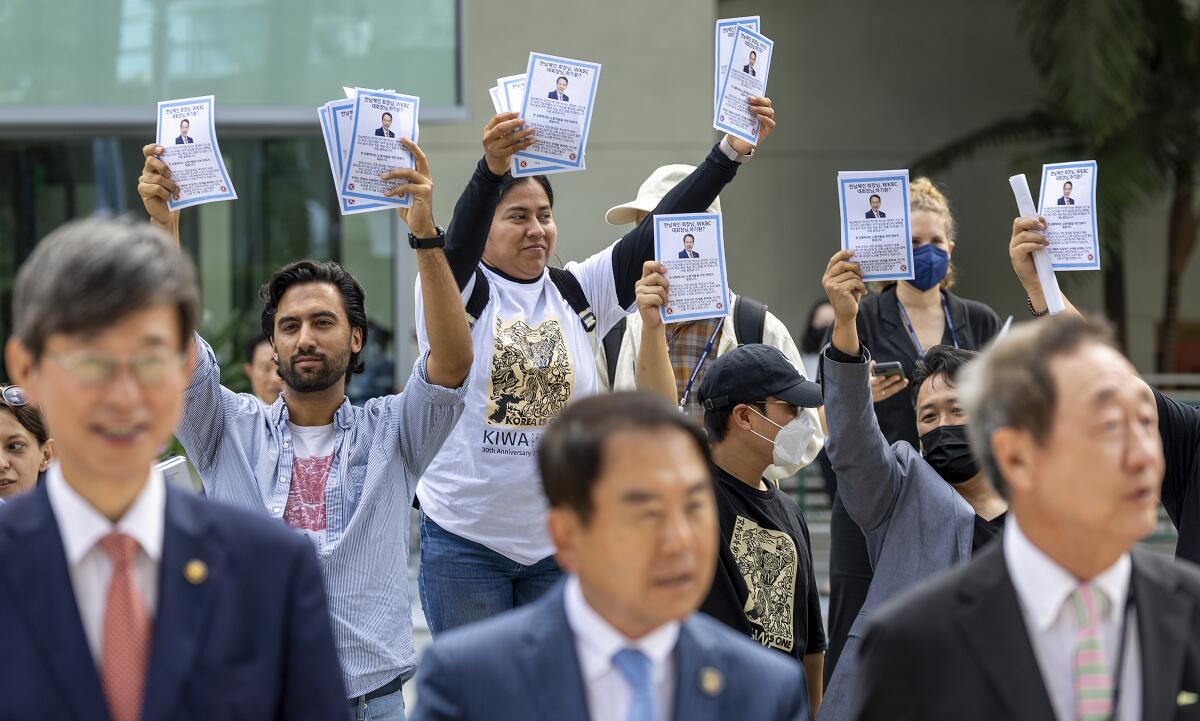 Protesters for wage rights at World Korean Business Convention at the Anaheim Convention Center.