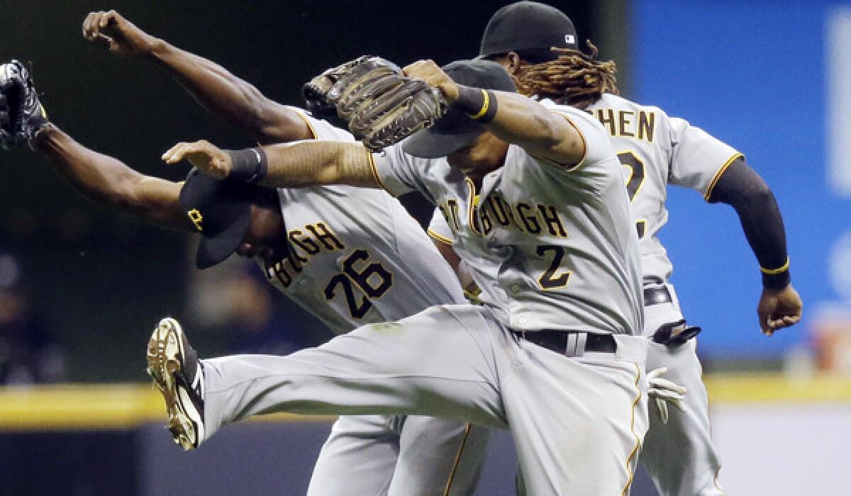 Pittsburgh teammates Felix Pie, left, Marlon Byrd, center, and Andrew McCutchen celebrate the Pirates' 4-3 win over the Milwaukee Brewers on Tuesday.