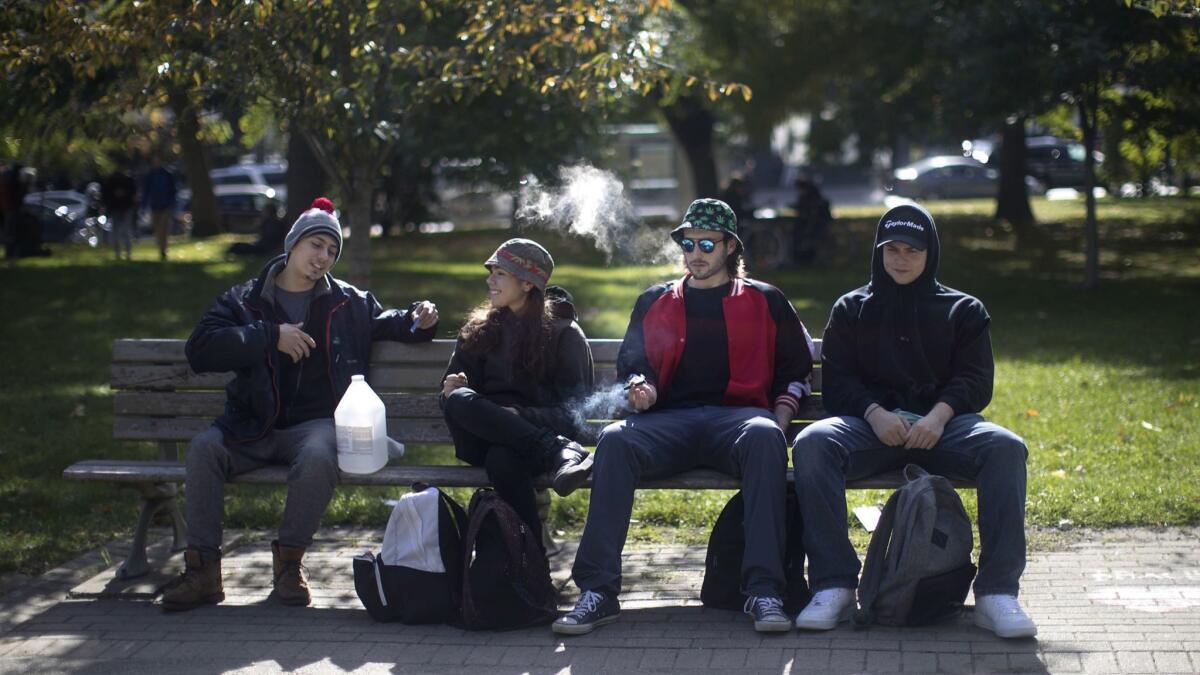 People smoke cannabis in a Toronto park on Oct. 17.