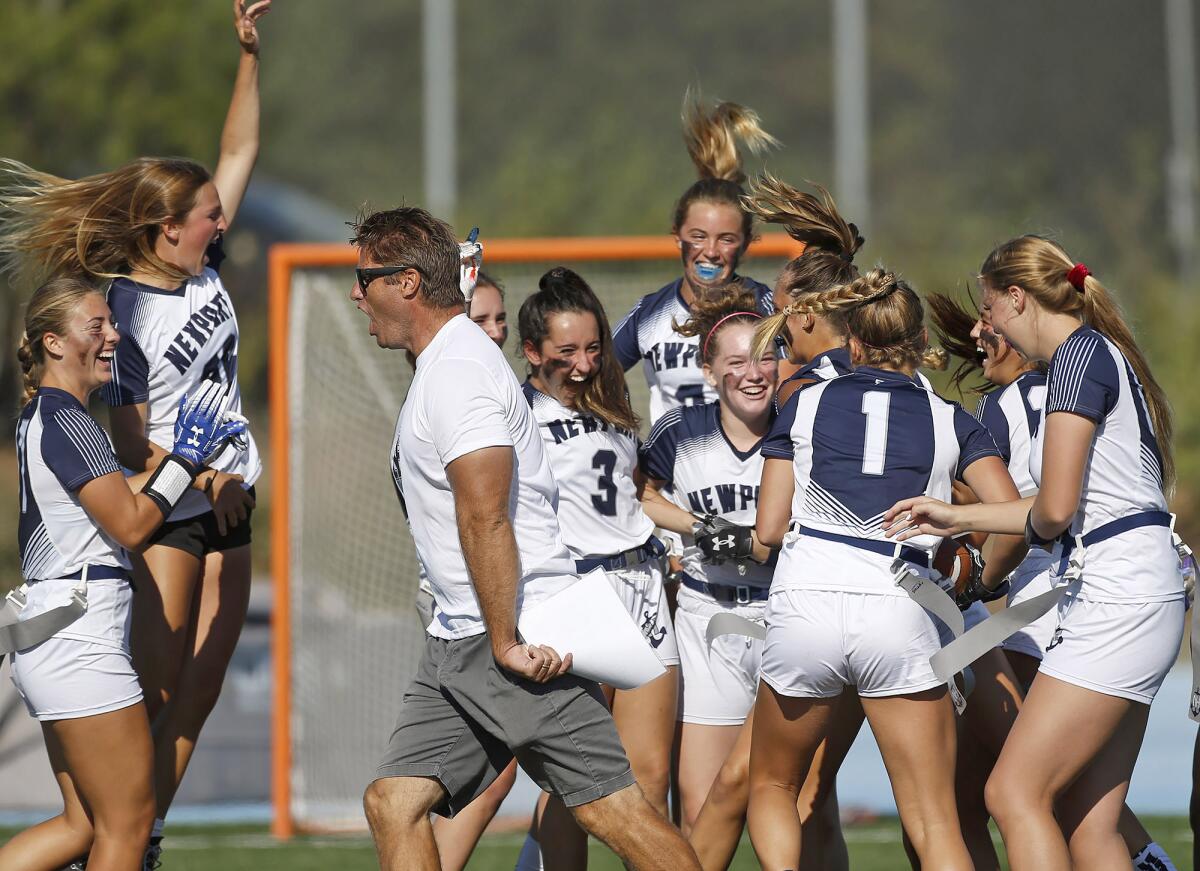 Newport Harbor girls' flag football celebrates the overtime win against rival Corona del Mar during Monday's game at CdM.