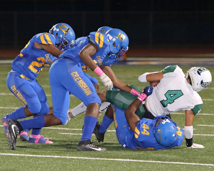 Crenshaw's Da'Shawn Hightower (44) tackles Dorsey's Kobie Davenport (4) during Crenshaw's 51-0 victory on Friday night.