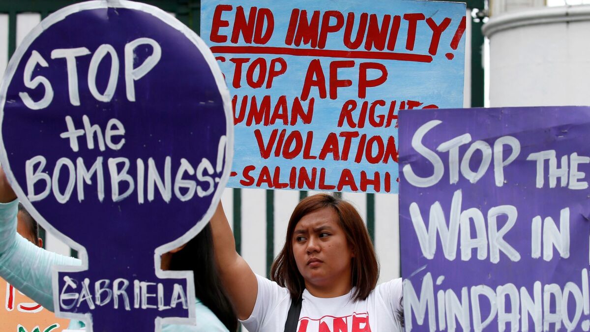 Demonstrators in Manila on July 7 protest Philippine President Rodrigo Duterte's declaration of martial law for the southern region of Mindanao.