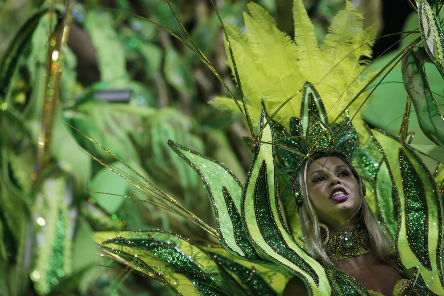 At Carnival celebrations at the Sambadrome in Rio de Janeiro, a performer from Imperatriz Leopoldinense samba school participates in the parade.