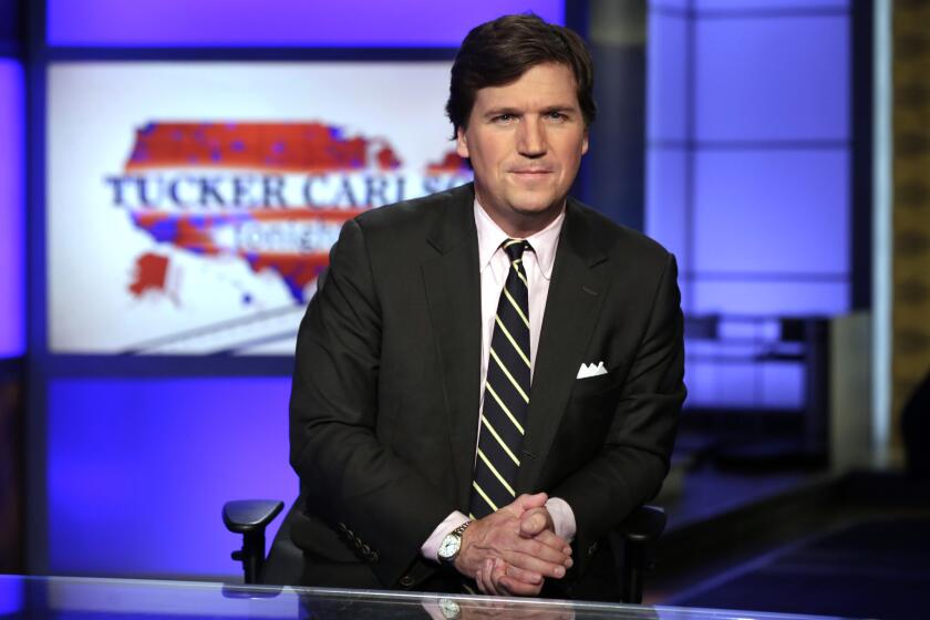 FILE - In this March 2, 2017 file photo, Tucker Carlson, host of "Tucker Carlson Tonight," poses for photos in a Fox News Channel studio, in New York. The Fox News host and longtime conservative commentator has a two-book deal with Threshold Editions, the publisher said Tuesday, May 2. Carlson also authored, Politicians, Partisans, and Parasites: My Adventures in Cable News, which came out in 2003. (AP Photo/Richard Drew, File)