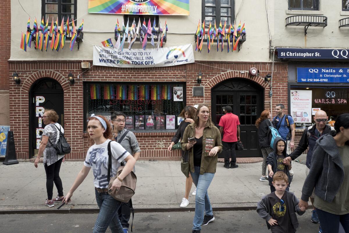 People pass the Stonewall Inn in New York in 2017.