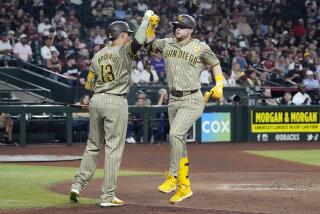 San Diego Padres' Jake Cronenworth, right, celebrates after his home run against the Arizona Diamondbacks with Padres' Manny Machado (13) during the fourth inning of a baseball game Friday, May 3, 2024, in Phoenix. (AP Photo/Ross D. Franklin)