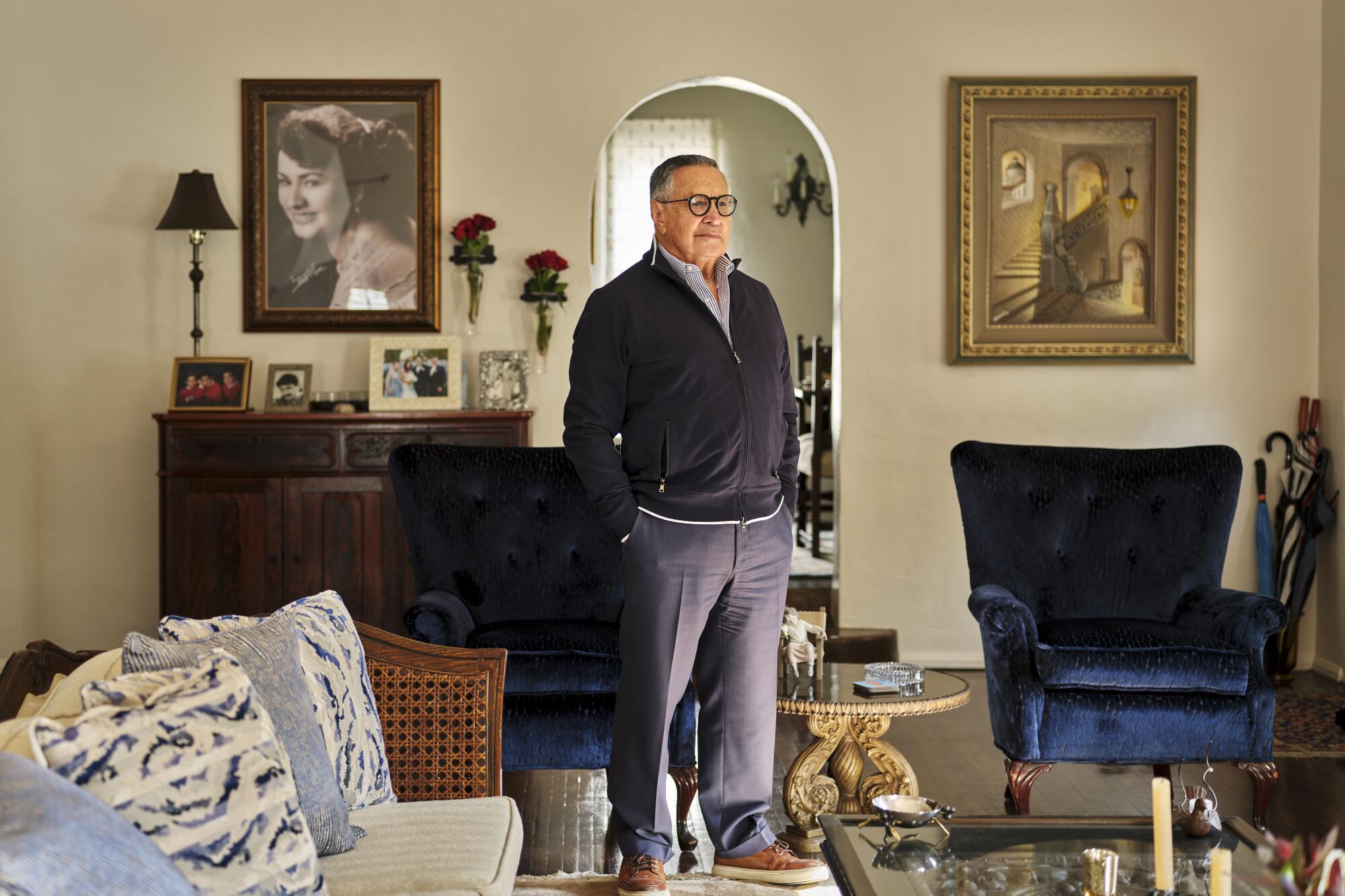 Jaime Jarrin stands in his home, hands in his pockets