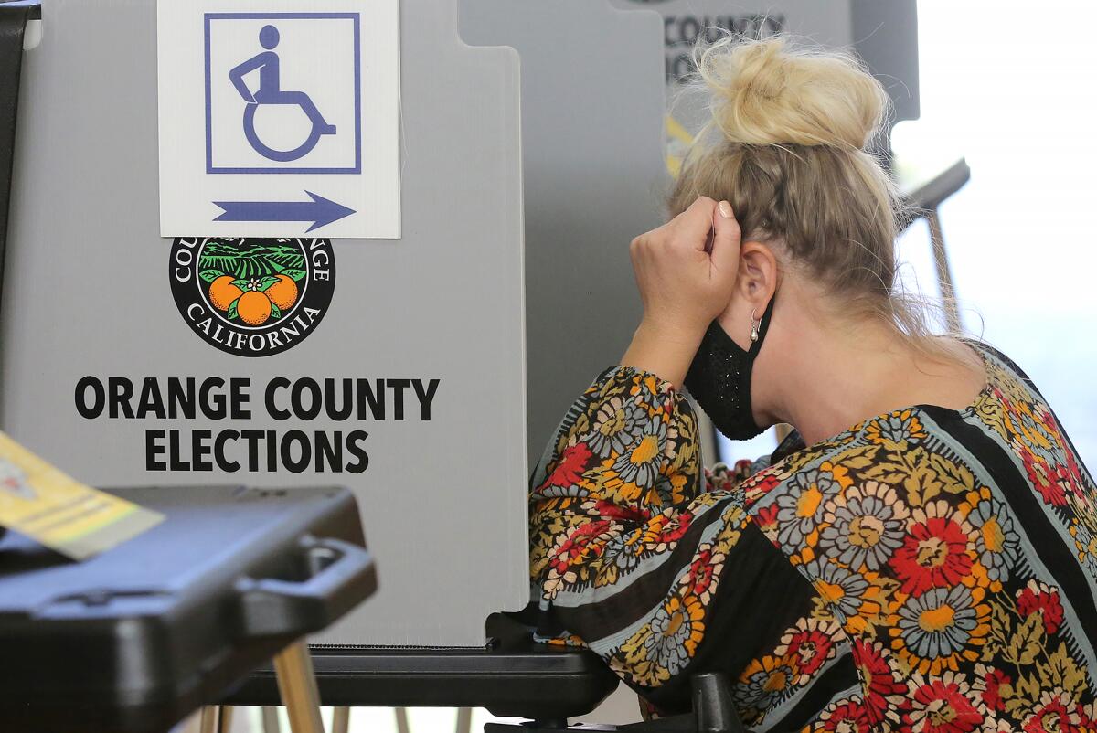 A voter fills out her ballot at the Lang Park voting center in Laguna Beach on Tuesday.