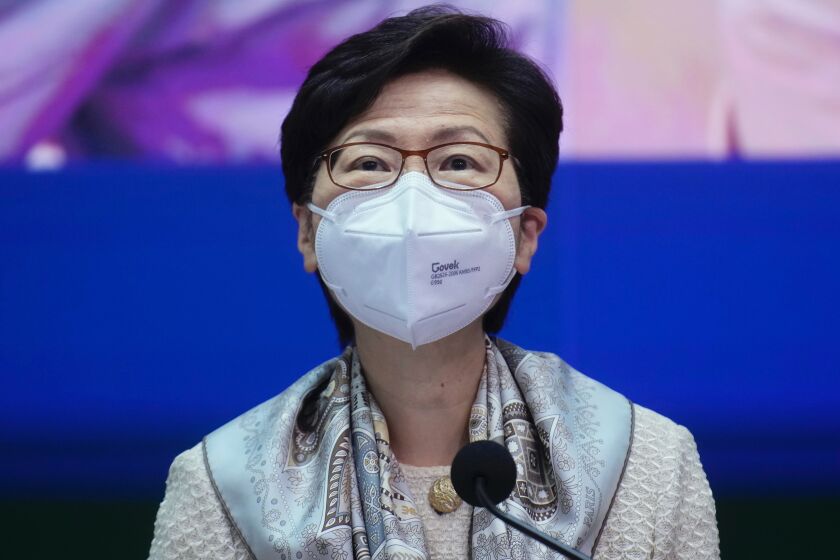 Hong Kong Chief Executive Carrie Lam listens to a reporter's question during a news conference in Hong Kong, Monday, March 21, 2022. (AP Photo/Vincent Yu, Pool)