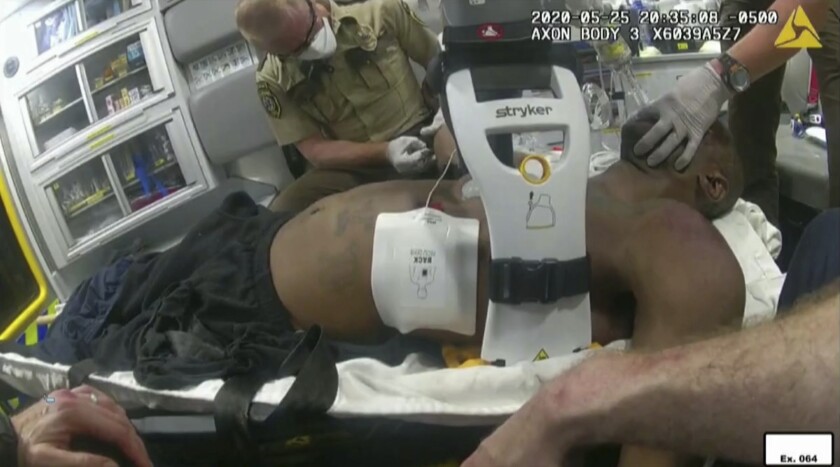 FILE - This image from police body camera video shows emergency personal tending to George Floyd after he had been loaded into an ambulance on May 25, 2020, in Minneapolis. A paramedic who treated Floyd on the day he was killed testified Wednesday, Jan. 26, 2022 at the federal civil rights trial of three former Minneapolis police officers that he wasn't told Floyd wasn't breathing and had no pulse when officers upgraded the urgency of an ambulance call. (Minneapolis Police Department via AP, File)