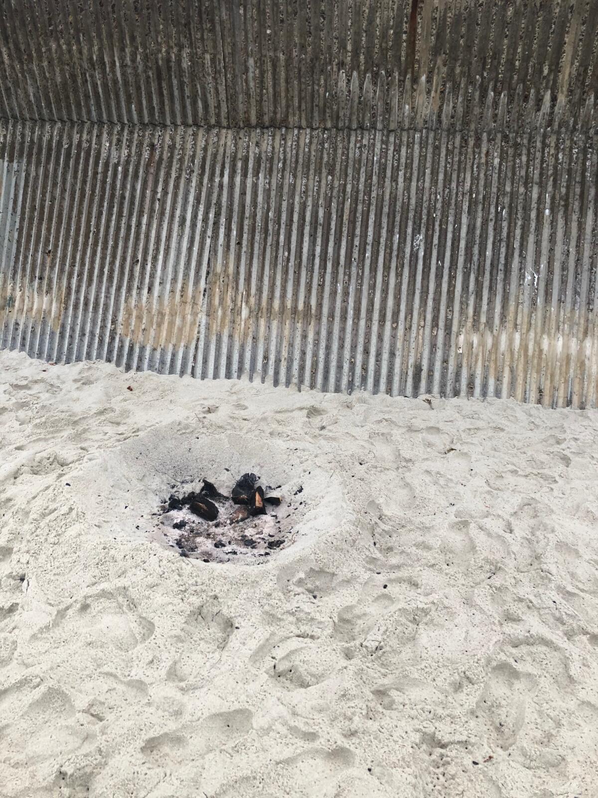 Remnants from a beach fire in the sand at Marine Street Beach.