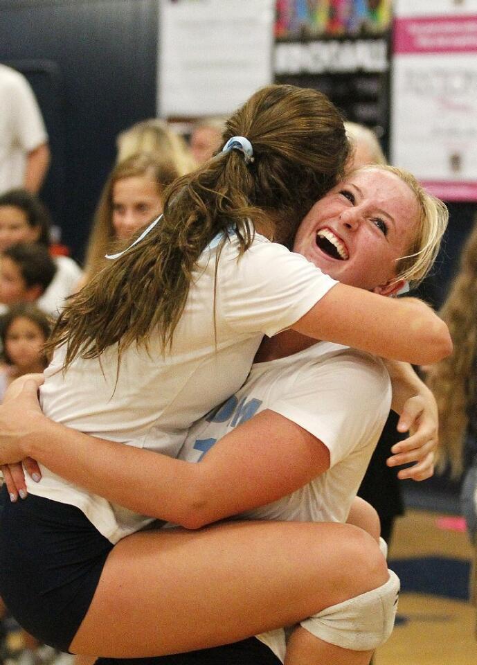 Corona del Mar High's Kylie Jones, left, celebrates a win over Newport Harbor with Katie Craig following the Battle of the Bay girls' volleyball match on Saturday.