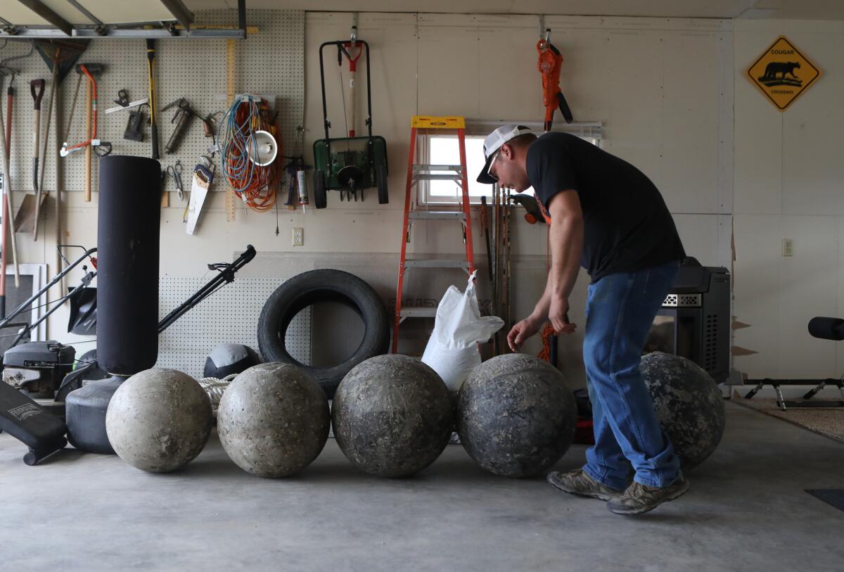 Cancer survivor Charley Butler is training for strongman competitions at his Sidney, Mont., home.