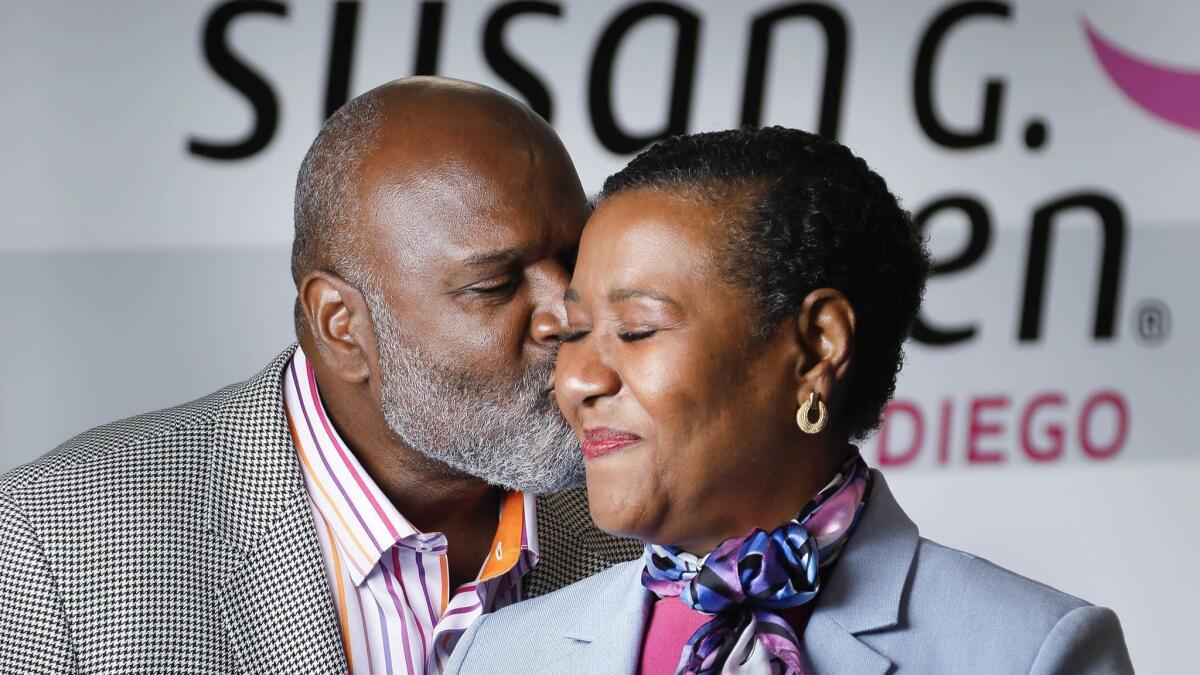 Douglas Gray, left, gives a kiss to his wife, Lilian Vanvieldt-Gray, who is Susan G. Komen San Diego's 2018 Honorary Breast Cancer Survivor. She has been an advocate to encourage black women to get mammograms and he was a leading Race for the Cure fundraiser in 2017.