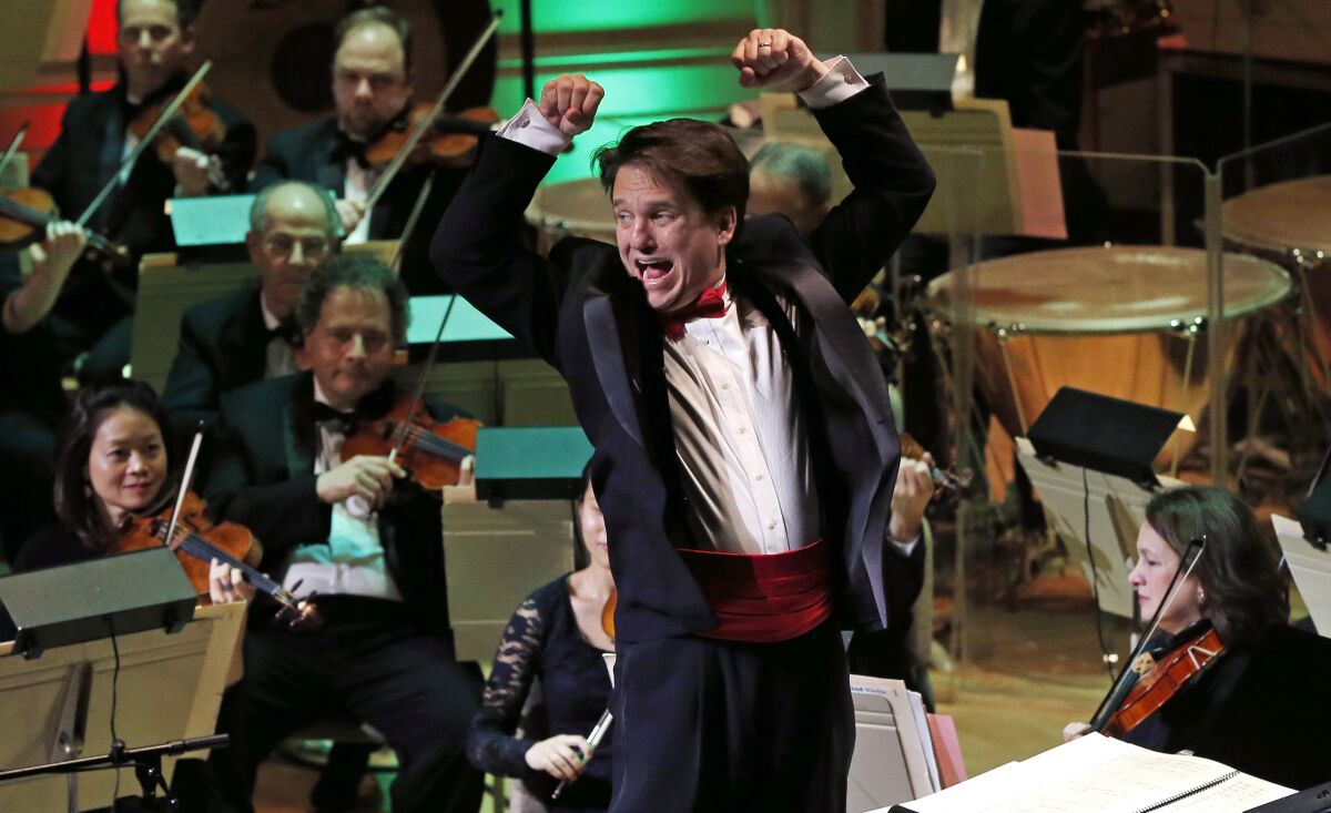 FILE - Boston Pops Conductor Keith Lockhart leads the 31st annual "A Company Christmas at Pops" at Symphony Hall, Dec. 10, 2014, in Boston. The Boston Pops orchestra is reviving springtime live performances for the first time since the pandemic began. The orchestra announced Thursday, March 17, 2022, its lineup for a full spring season at Symphony Hall, in Boston. (AP Photo/Elise Amendola, File)