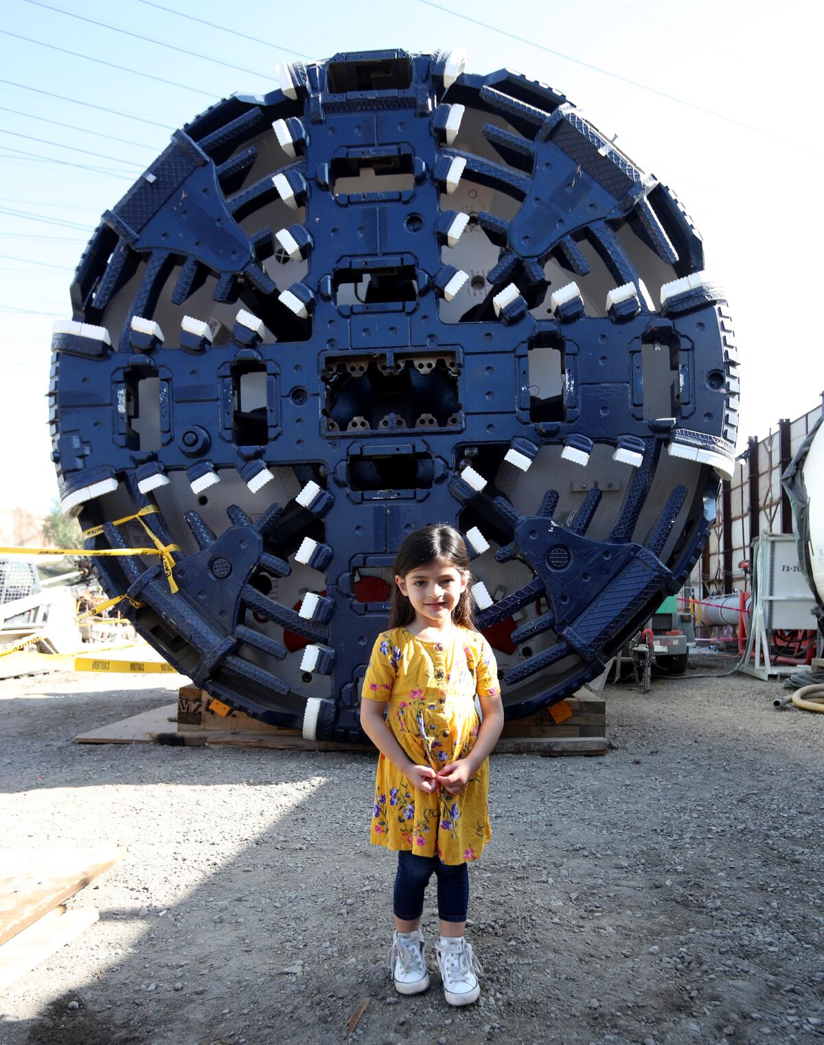 Luciana Torroledo, 4, of Culver City, stands in front of the earth-pressure-balance tunnel-boring machine named after her, during open house for the L.A. Water Infrastructure project, at Johnny Carson Park South, in Burbank on Saturday, Feb. 8.
