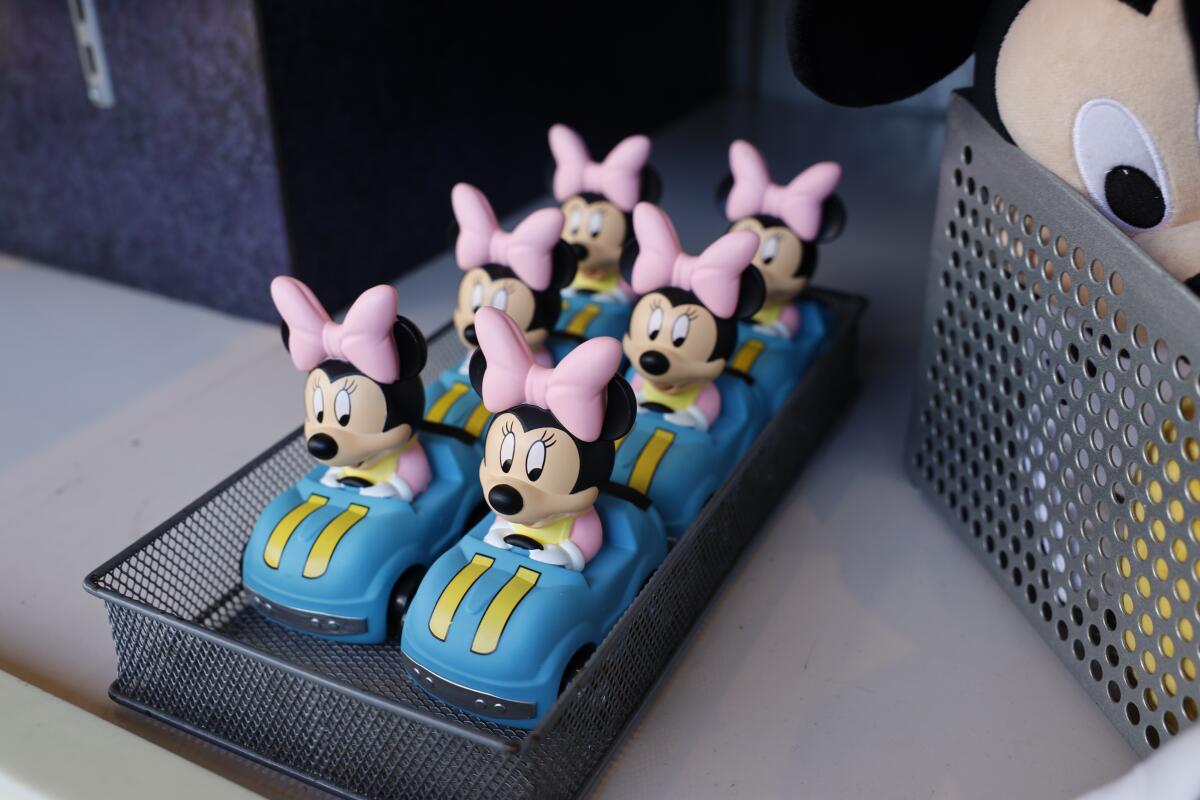 Minnie Mouse rides in a miniature Autopia car, for sale outside the attraction at Disneyland in Anaheim.