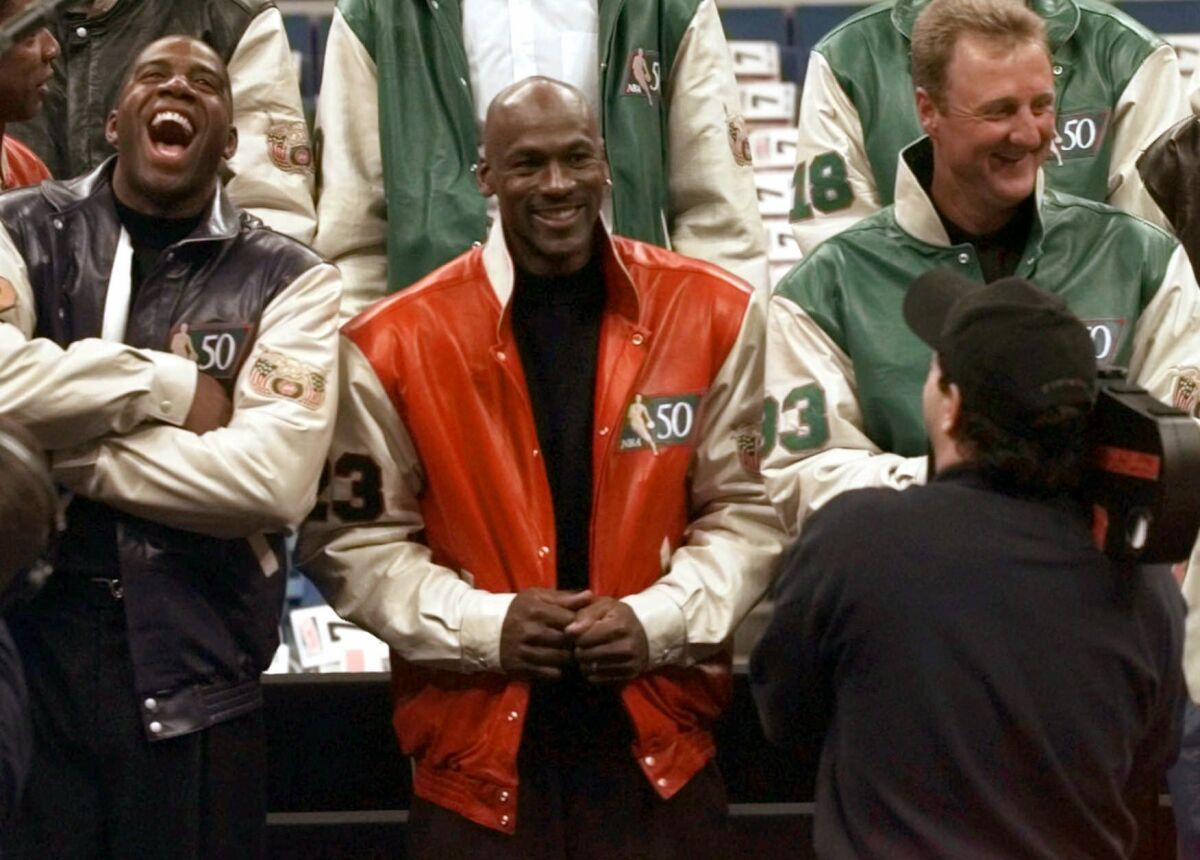 FILE - Former Los Angeles Lakers player Magic Johnson, left, Chicago Bulls' Michael Jordan and former Boston Celtic Larry Bird pose for pictures during a photo session with the Legends of the NBA Saturday, Feb. 8, 1997, in Cleveland. Some of the NBAs most iconic players will be in attendance when the league celebrates its 75th Anniversary Team during a special halftime ceremony at Sunday's All-Star Game. The official list of players has not yet been announced. (AP Photo/Mark Duncan, File)