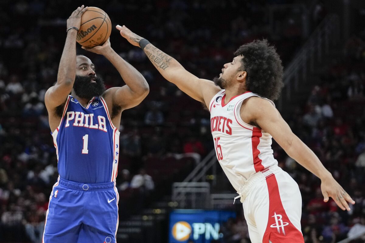 Philadelphia 76ers guard James Harden (1) shoots a three point basket as Houston Rockets guard Daishen Nix defends during the first half of an NBA basketball game, Monday, Dec. 5, 2022, in Houston. (AP Photo/Eric Christian Smith)